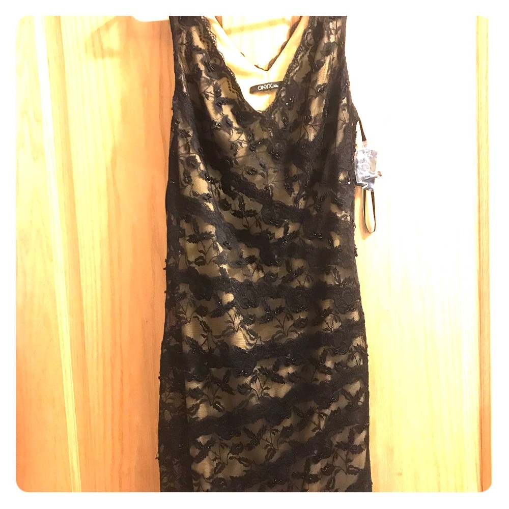 Cocktail length sleeveless black lace dress